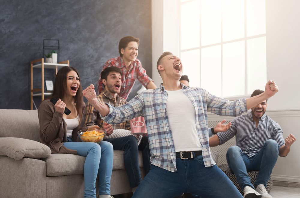 Family celebrating while sitting on a sofa